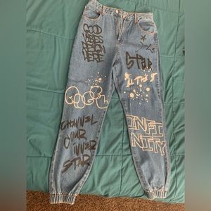 Graffiti joggers. Denim. Baggy and cuffed at the bottom of jeans
